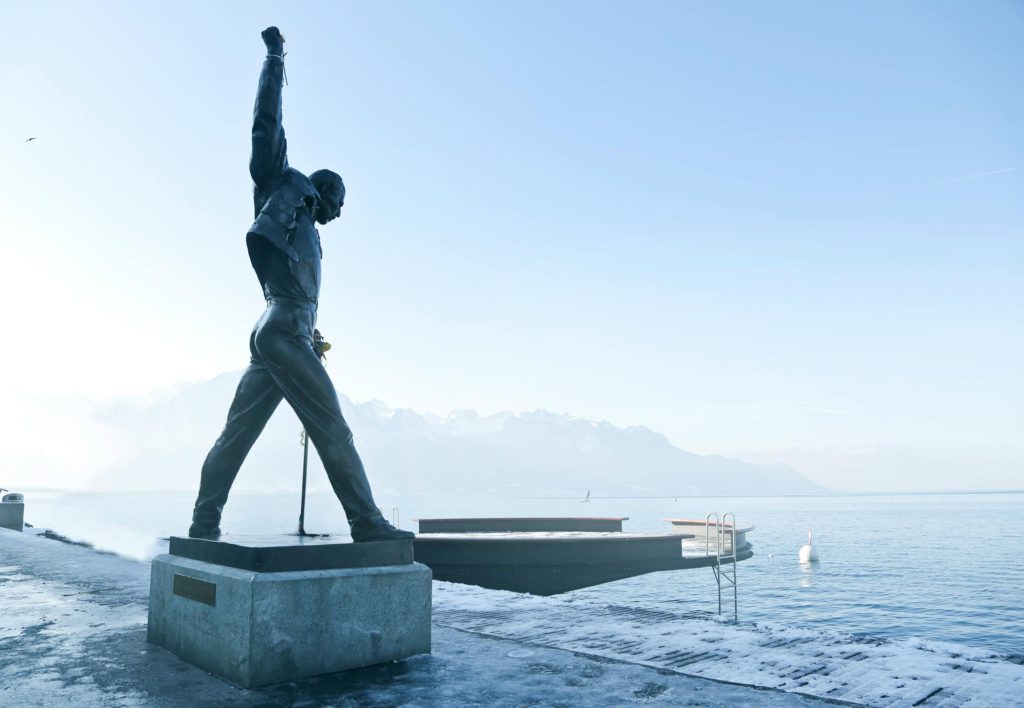 Montreux : Grey Metal Statue of a Man Raising his Hands